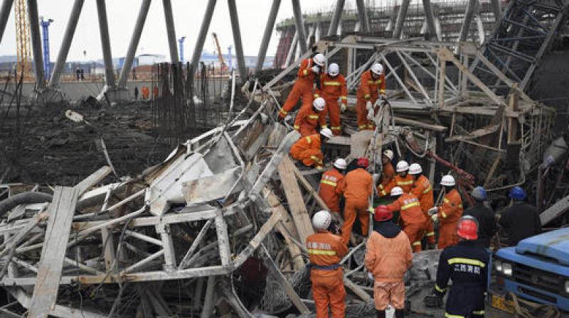 In this photo released by Xinhua News Agency, rescue workers look for survivors after a work platform collapsed at the Fengcheng power plant in eastern Chinas Jiangxi Province. (Photo: AP)