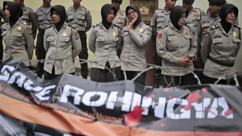 Muslim police women stand guard during a Muslim rally against the persecution of Rohingya Muslims, outside the Embassy of Myanmar in Jakarta, Indonesia. (Photo: AP)