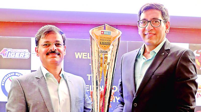 MD & CEO of L&T Metro Rail Hyderabad KVB Reddy (left) and TPKL League Commissioner Sanjay Reddy unveil the trophy at an event in Hyderabad on Tuesday.