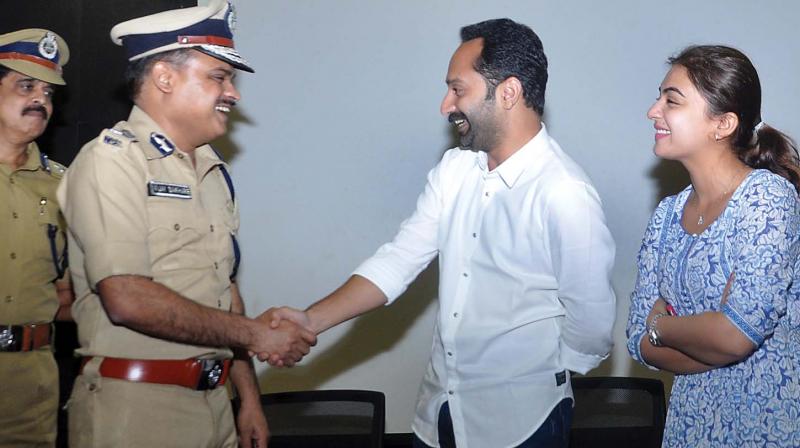 Actor couple Fahadh Faasil and Nazriya Nazim with  Ernakulam range IG Vijay Sakhare and city Police Commissioner M.P. Dinesh at the curtain raiser function ahead of COCON18  at Infopark in Kochi on Tuesday (Photo: SUNOJ NINAN MATHEW)
