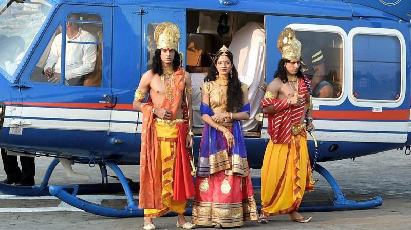 Artistes dressed up as Lord Rama, Sita and Lakshman arrive by a chopper for Deepotsav celebrations in Ayodhya on Wednesday (Photo: PTI)