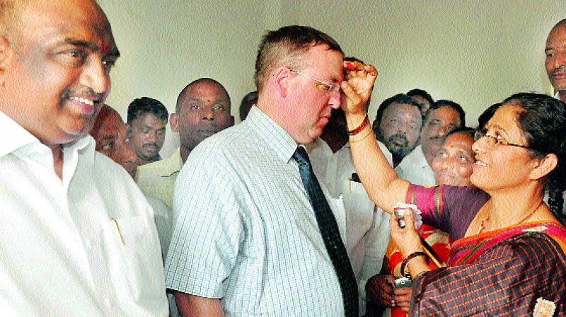 British deputy high commissioner Andrew Fleming is welcomed by a woman during his visit on Thursday to the adopted village of Chief Minister K. Chandrasekhar Rao.