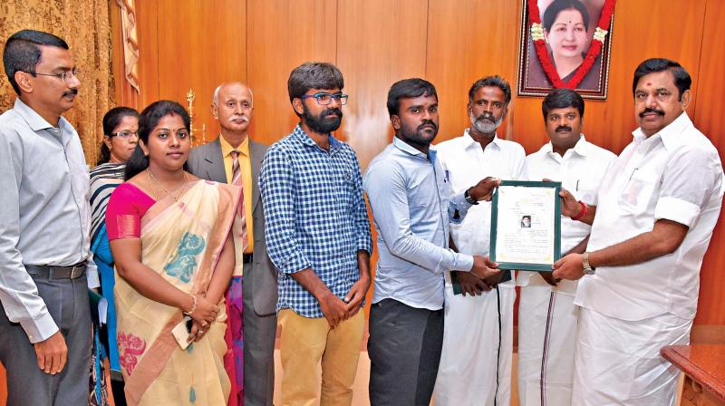 Chief Minister Edappadi K. Palaniswami hands over the appointment order to Sathish Kumar, brother of slain medical aspirant Anitha, as junior assistant in the  state-run Tamil Nadu Medical Plant Farms and Herbal Medicine Corporation Limited (Tampcol). Anithas father and government officials look on (Photo: DC)