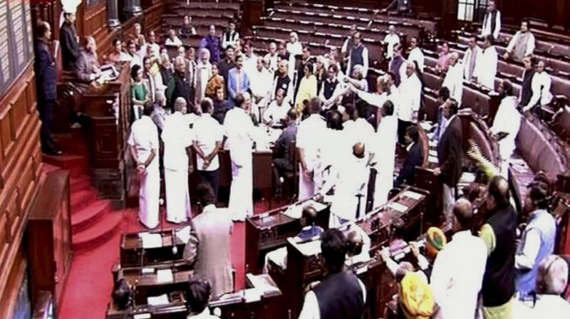Members protest in the Rajya Sabha during the winter session of Parliament in New Delhi. (Photo: PTI)