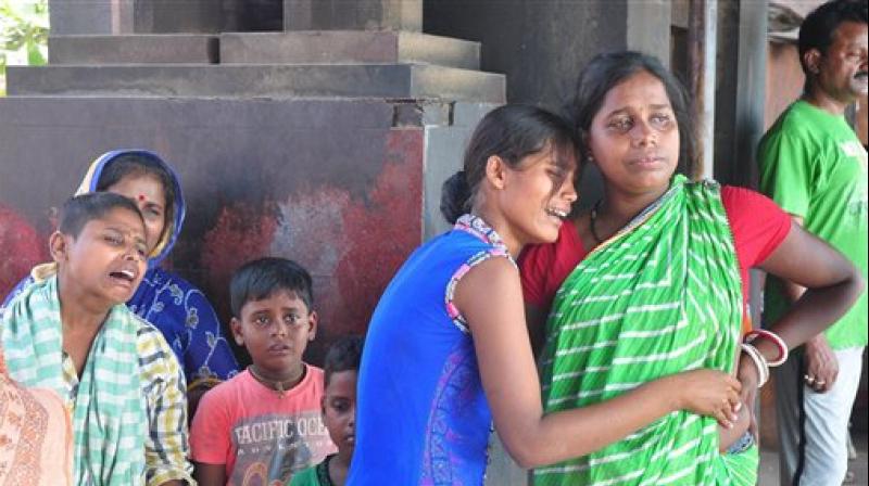 Family members of a SUM hospital fire victim mourn during his cremation in Puri. (Photo: PTI)