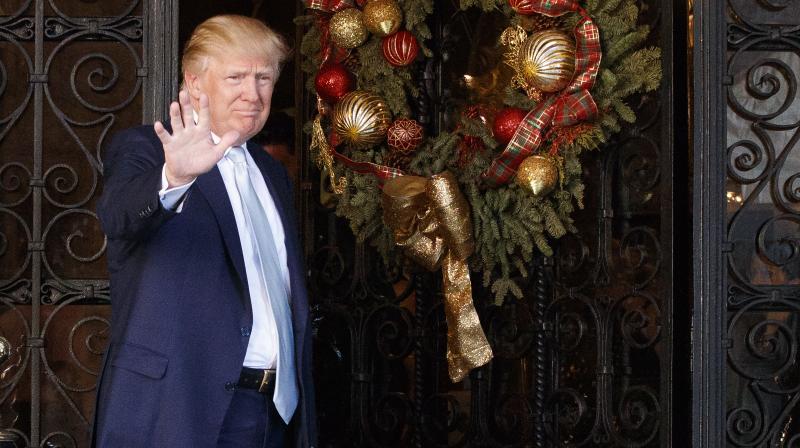 President-elect Donald Trump stands at the entrance of Mar-a-Lago and waves to reporters after meeting with Carlyle Group co-founder and co-CEO David Rubenstein, Wednesday. (Photo: AP)