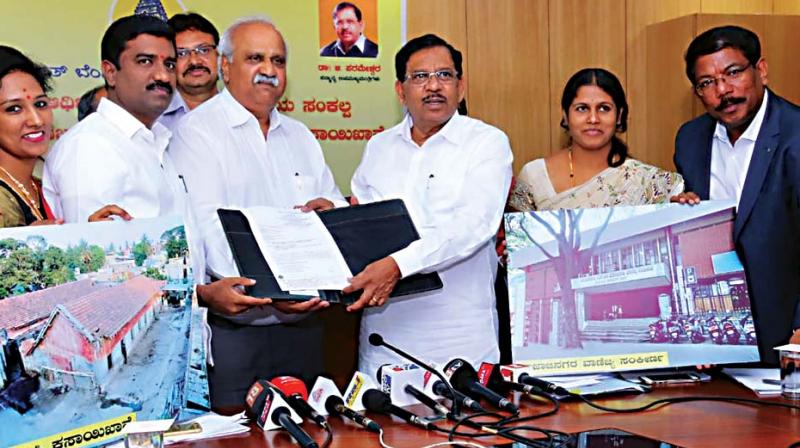 Deputy Chief Minister G. Parameshwar with documents related to BBMP properties that were released in Bengaluru on Friday after being mortgaged with HUDCO (Image DC)
