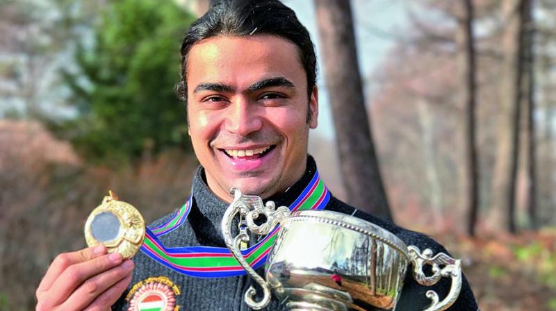 Shiva Keshavan poses with the Asian Luge Championship gold medal and trophy in Nagano, Japan, on Friday.