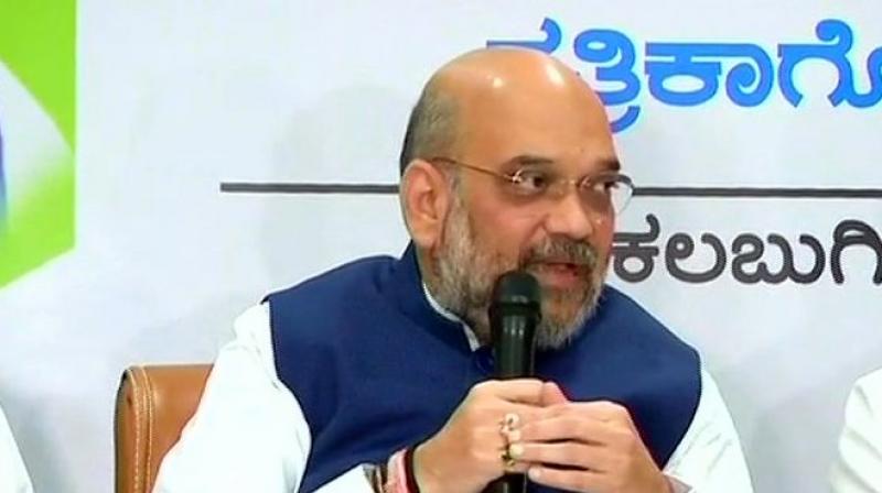 BJP president Amit Shah also hit out at the Sidaramaiah government, accusing it of following three Ds -- Dhokha (cheating), Dadagiri (goondaism) and dynastic politics. (Photo: ANI | Twitter)