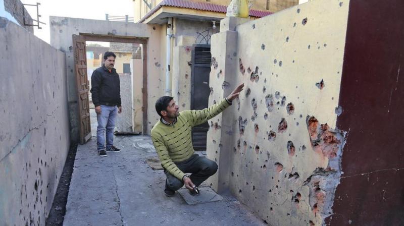 Villager shows a damaged section of his house after shelling from the Pakistani side on the India-Pakistan international border at Arnia Sector about 45km from Jammu on Saturday. (Photo: PTI)