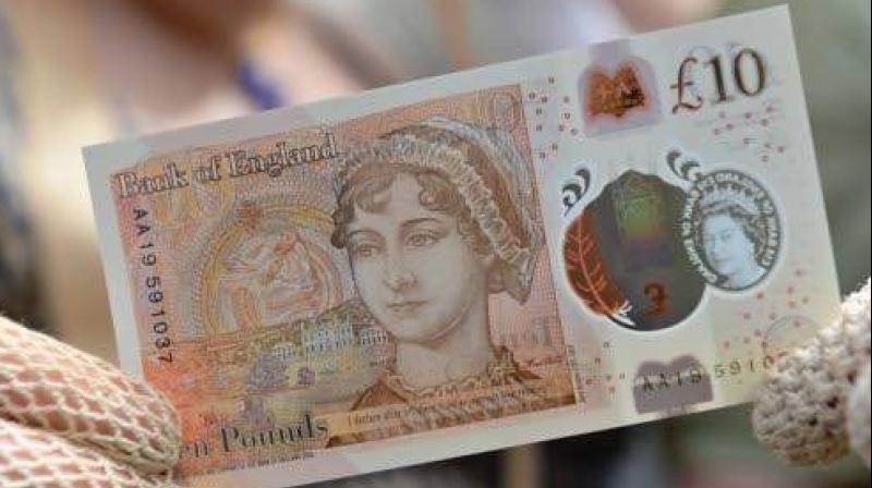 One of the new ten pound notes, featuring author Jane Austen, duting its launch at Winchester Cathedral in Winchester, southern England. (Photo: AFP)
