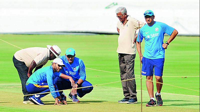 Team India fielding coach R. Sridhar (left) and head coach Anil Kumble (centre) inspect the wicket at the Rajiv Gandhi International Cricket Stadium in Hyderabad on Monday as batting coach Sanjay Bangar (right) looks on (Photo: DC)
