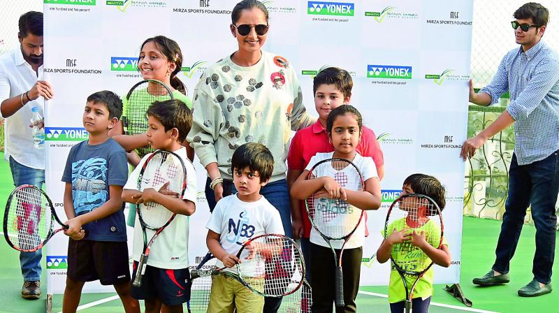 Sania Mirza poses with kids at the newly-opened Grassroot Level wing of the Sania Mirza Tennis Academy next to her house in Jubilee Hills on Monday (Photo: R. Pavan)