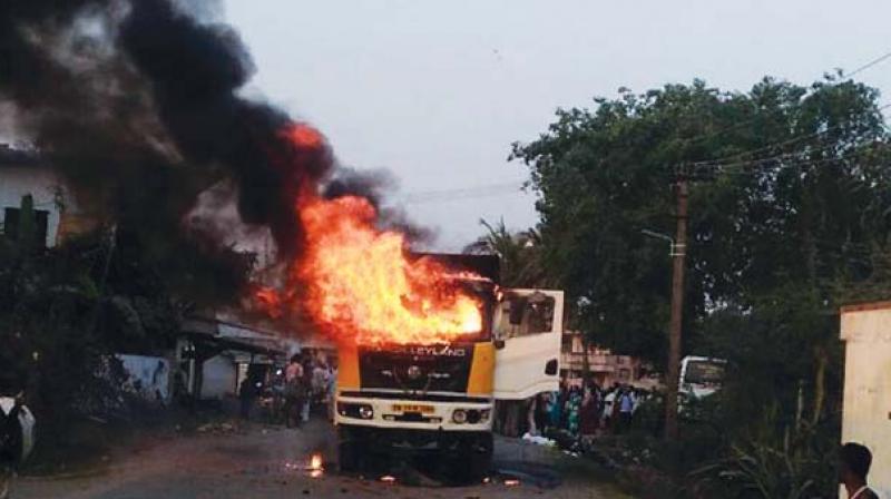 Villagers arson a tipper lorry after it was involved in a fatal accident killing a girl student, near Chithalapakkam in Wallajahbad, Kancheepuram,  on Monday evening. (Photo: DC)