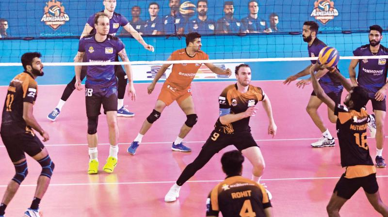 Black Hawks Hyderabads Muthusamy sets up for Carson Clark (centre) against the Ahmedabad Defenders during a Pro Volleyball League match at the Rajiv Gandhi Indoor Stadium in Kochi on Monday. (Photo: ARUN CHANDRABOSE)