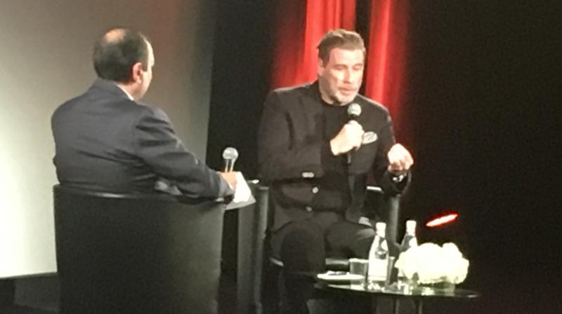 John Travolta in conversation with French journalist Didier Allouche at Cannes on Wednesday.