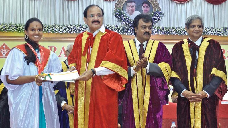 Union Minister M.Venkaiah Naidu presents five gold medals to MBBS graduate Uma Ravishankar at Sri Ramachandra University in Chennai on Sunday. Also seen are University chancellor V.R.Venkataachalam and VC J.S.N. Murthy. (Photo: DC)