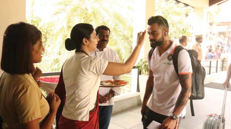Indian cricket team captain Virat Kohli being accorded a traditional welcome by the staff at Leela Raviz, Kovalam, on Tuesday.	By Arrangement