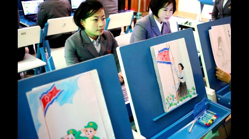 Students make story boards depicting North Korean flags being raised during a multimedia production class at Pyongyangs teacher training college, North Korea. (Photo: AP)