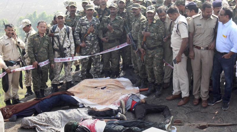 Police investigate the encounter site at the hillocks of Acharpura village after the STF killed 8 Students of Islamic Movement of India (SIMI). (Photo: PTI)