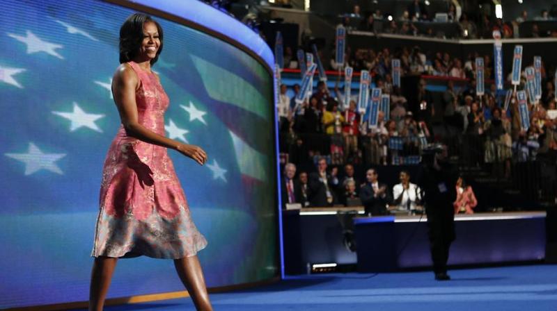 First lady Michelle Obama, dressed in a Tracy Reese pink silk jaquard dress, walks on the stage at the Democratic National Convention in Charlotte. (Photo: AP)