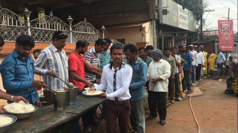 People queue up to collect free lunch being distributed by an Old City group for unemployed persons, following the November 8 demonetisation, in Hyderabad on Saturday.