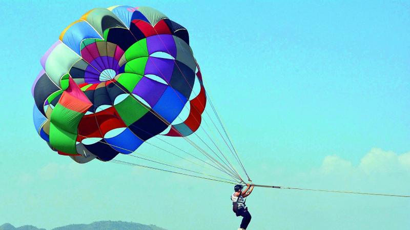 Youth participate in parasailing at Kanakadurgamma Varadhi organised by Vijayawada Adventure Club on Saturday. (Photo: DC)