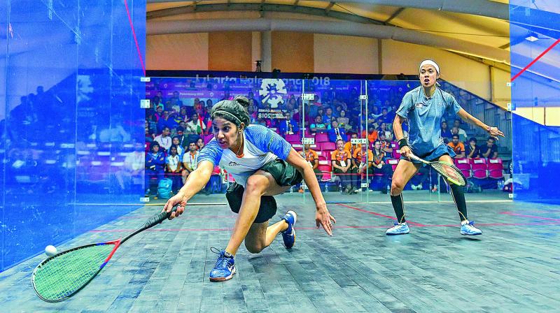 Joshna Chinappa (left) of India reaches for the ball during her match against Nicol David of Malaysia in the womens squash team event semifinal on Friday. India defeated the defending champions 2-0. (Photo:PTI)