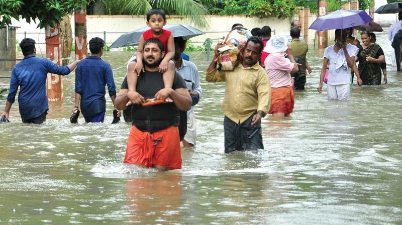 File pic of people wading through flood waters.
