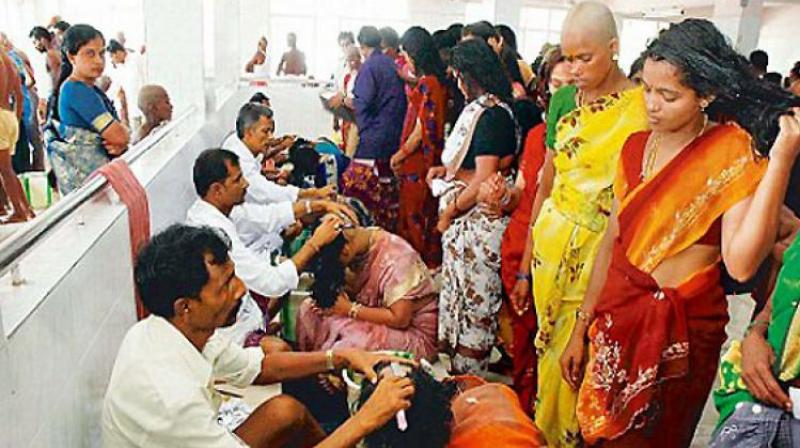 Women devotees donating hair at a temple