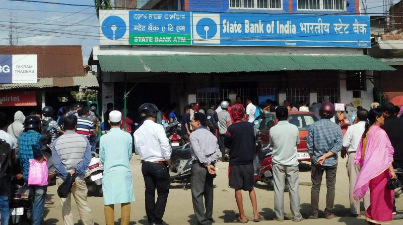 People wait outside a bank to exchange their old Rs 500 and Rs 1000 notes. (Photo: PTI)