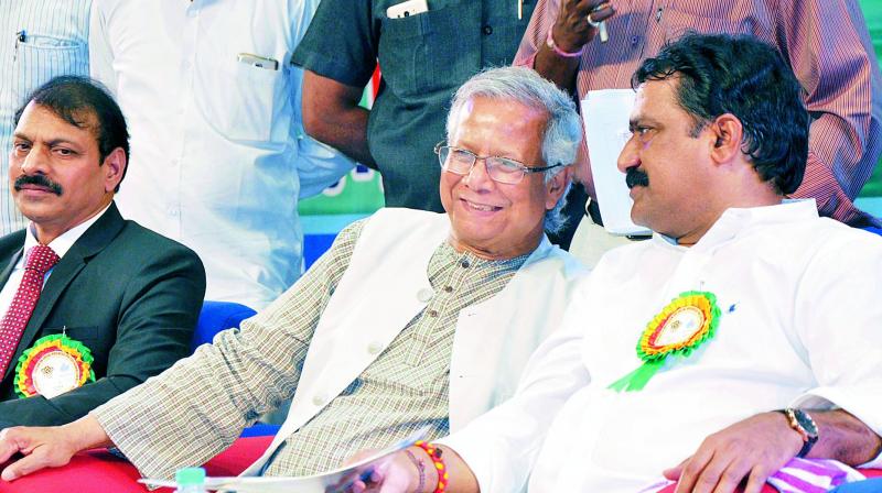 HRD minister Ganta Srinivasa Rao and Nobel Laureate from Bangladesh Muhammad Yunus share a light moment during International Symposium on Social Business for Sustainable Development, conducted by Andhra University at VUDA Childrens Theatre on Thursday. 	(Photo: DECCAN CHRONICLE)