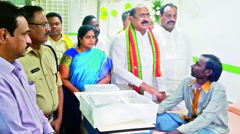 Health minister Kamineni Srinivasa Rao interacts with the patients during an inspection of a hospital at Palakonda in Srikakulam district on Thursday.