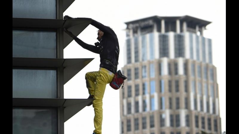Alain Robert, dubbed the French spiderman, climbed the 47-storey GT Tower without safety equipment. (Photo: AFP)