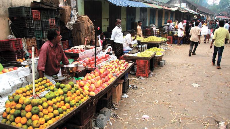 Street vendors waiting for customers at Palayam market in Kozhikode on Sunday.