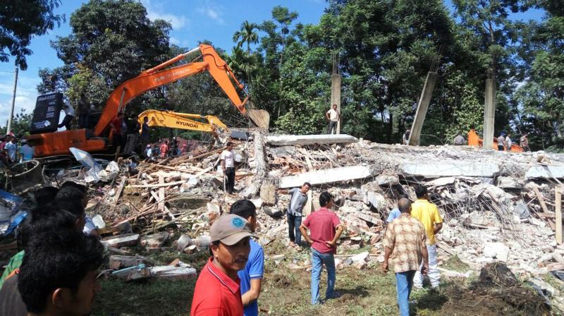 A strong undersea earthquake rocked Indonesias Aceh province early on Wednesday, killing at least 52 people and causing dozens of buildings to collapse.