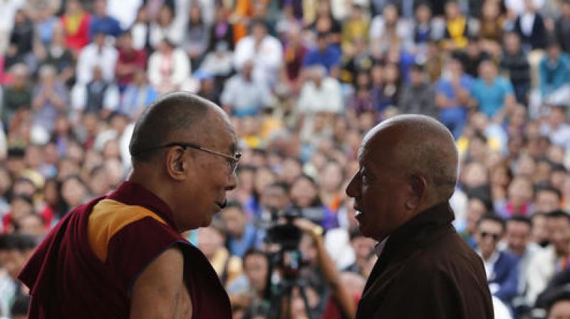 Dalai Lama, left, interacts with fellow Tibetan at an event to inaugurate the Dalai Lama Institute for Higher Education on the outskirts of Bangalore. (Photo: AP)