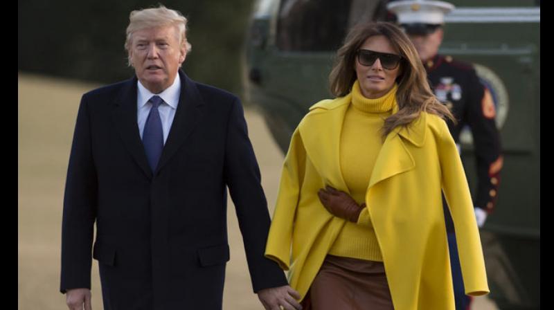 Melanias long yellow overcoat is deceivingly draped over her shoulders leading the President to mistakenly grab her sleeves instead of her hand. (Photo: AFP)