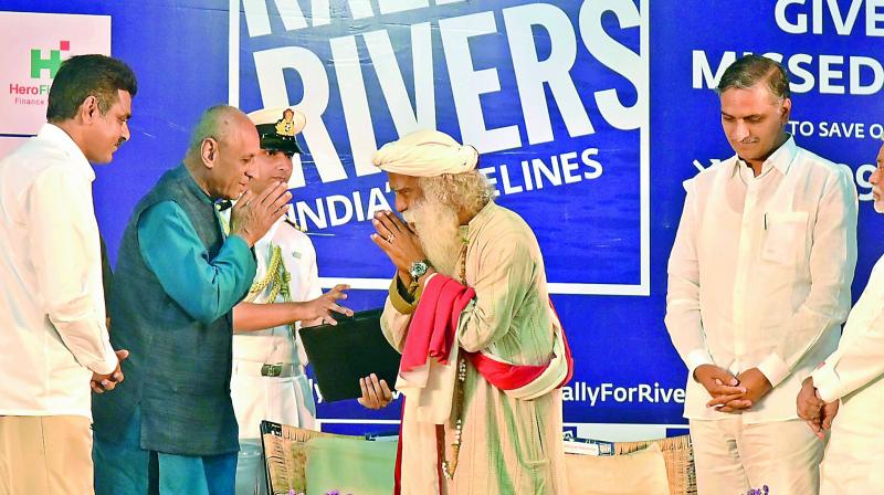 Governor E.S.L. Narsimhan and Sadhguru Jaggi Vasudev interact with each other during the Rally for Rivers campaign. Minister Harish Rao (right) and MP Konda Vishweshwar Reddy (left) were also present during the campaign held at Gachibowli Indoor stadium on Thursday.  (Photo:DC)