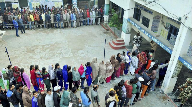 Voters standing in queues to cast their votes during the Punjab Assembly Election at a polling station in Patiala on Saturday. (Photo: PTI)