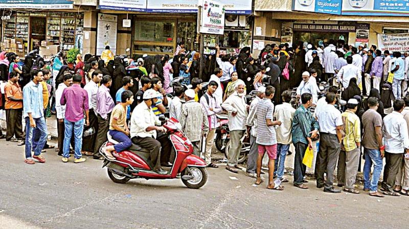 People continue to line up outside banks after the demonetization, in Bengaluru on Sunday. (Photo:  DC)