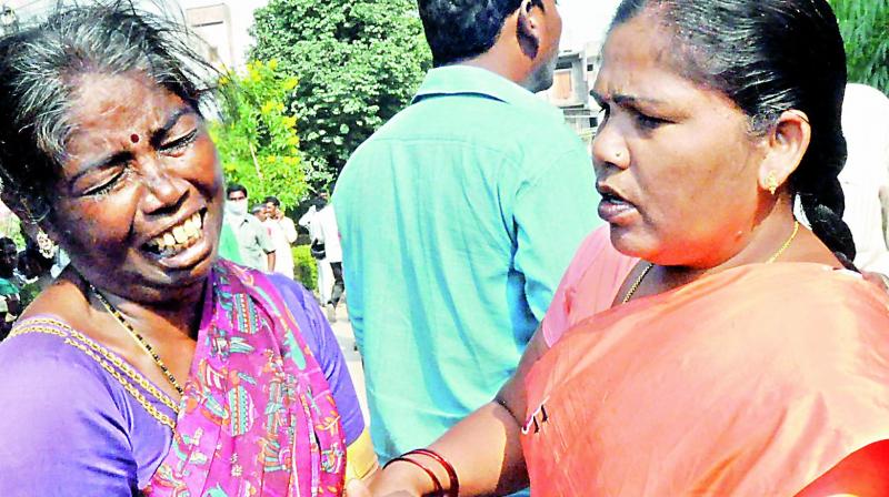 A woman tries to console a family member of one a person who died in the bus crash in Jagtial.(Photo: DC)