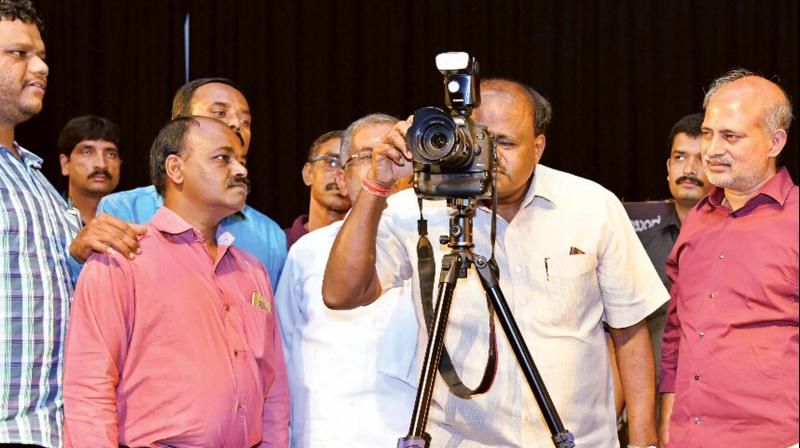 CM H.D. Kumaraswamy at an exhibition of photographs held as part of World Photography Day in Mysuru on Tuesday (Photo: KPN)