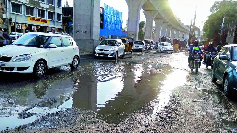 With the arrival of the rains, vehicles ply through damaged roads at Puthlibowli in Koti on Monday. (Photo: DC)