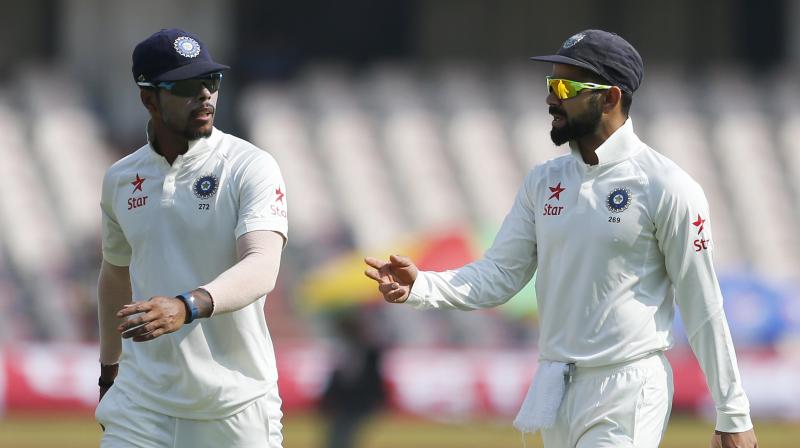 Umesh Yadav and Virat Kohli during the Test against Bangladesh. (Photo: AP)