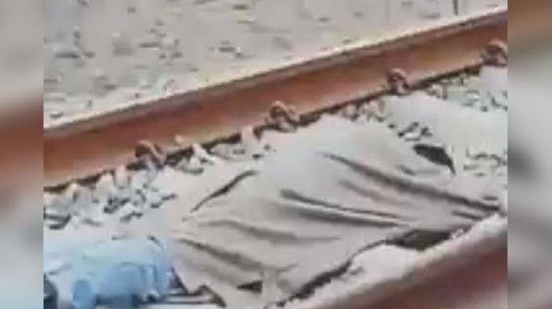 A man lying on a railway track while a speeding train passes over him, has taken the social media by storm, prompting calls for strict action to prevent it from becoming a trend. (Photo: Screengrab)
