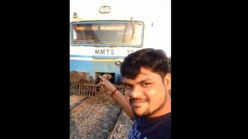 In the video clip that emerged on Wednesday, the man in his early 20s smiles at his smartphone camera and kept his right arm pointed towards the approaching MMTS train. (Photo: Screengrab)