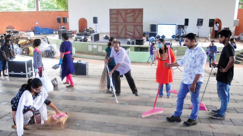 Volunteers clean the flood relief collection centre at Nishagandhi Auditorium in Thiruvananthapuram on Sunday