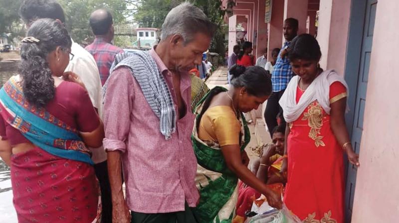 A family which left camp waits for ferry boat at Alappuzha boat jetty on Sunday. (Photo: DC)