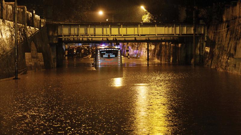 A KSRTC bus stuck at the Kino Theatre underpass following the heavy downpour on Tuesday evening. (Photo: DC)